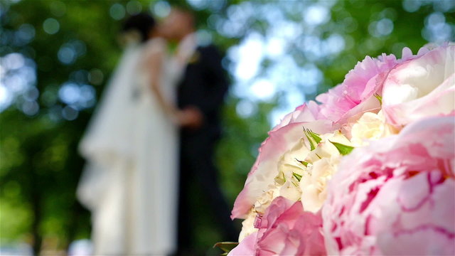  flowers and Defocused figures of wedding couple