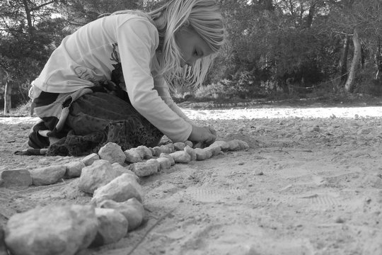 girl playing with stones