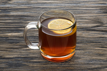 Cup of tea with lemon on the wooden table