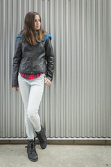 Young Teen Girl Standing Against Metal Wall