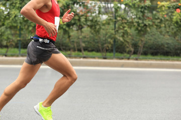 Marathon runner running on city road
