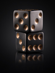 two black dice on a black background