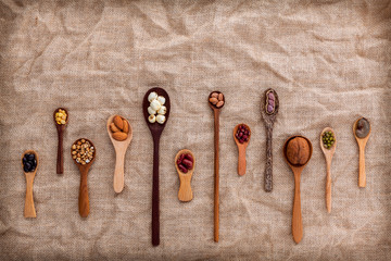 Mixed beans and lentils in the white bowl  on brown background.