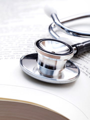 Stethoscope on a textbooks with shallow depth of field for medic