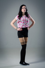 Young stylish woman wearing shorts. Studio shot.
