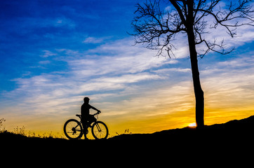 Fototapeta na wymiar Boy riding bicycle silhouette