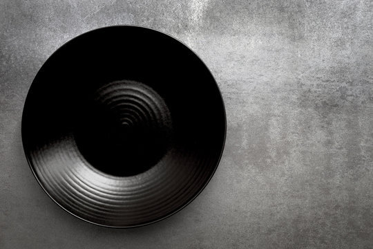 Empty Round Black Plate over Slate