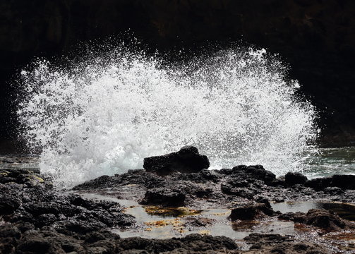 Wave Crashing On Rocks And Splashing Foam