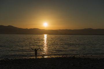 girl at sunrise over the sea