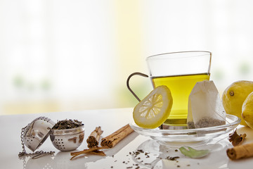 Green tea with cinnamon lemon and infusers front view