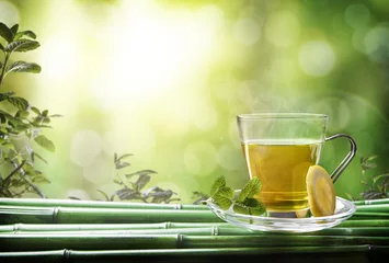 Afwasbaar Fotobehang Thee Oriental green tea with mint and lemon on bamboo front