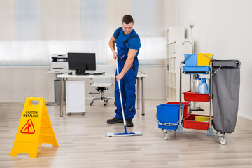 Janitor Mopping Floor In Office