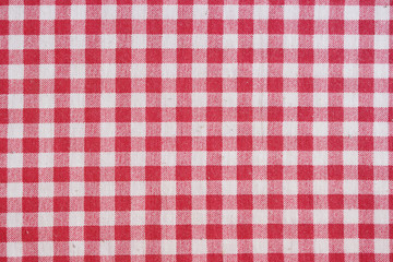 Red picnic tablecloth background, checkered fabric.