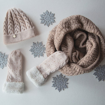 woolen light blue scarf, gloves and hat over white