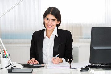 Accountant Calculating Finance With Calculator At Desk