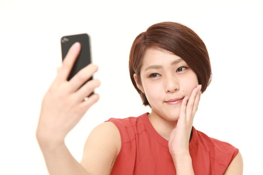 young Japanese woman takes a selfie