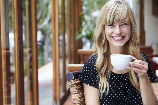 Portrait of young woman taking a coffee break