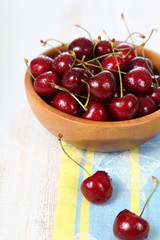 Ripe cherry in a wooden bowl