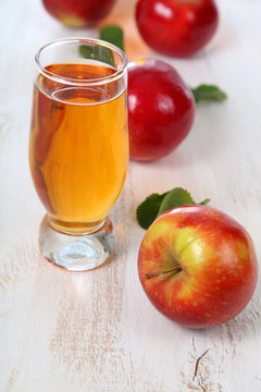 Apple juice and apples on a  wooden table