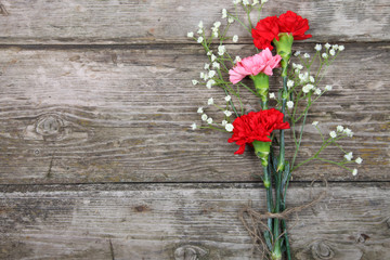 Bouquet of carnations on a wooden table