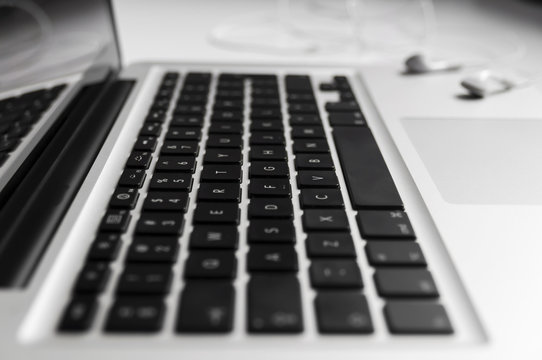 Top view of the keyboard of the laptop on Desk with headphones close