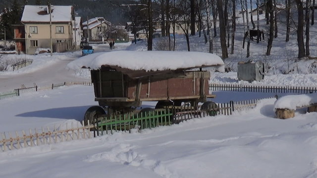 Car passing by horse cart and horses in the winter video stock footage, Govedartsi Village, Bulgaria