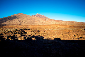Fototapeta na wymiar Volcanic landscape with car shadow