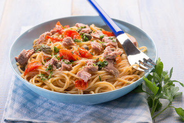 spaghetti with tuna capers and  tomatoes, selective focus