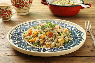  Quinoa insalata con verdure in piatto di ceramica  sfondo tavolo di cucina rustico