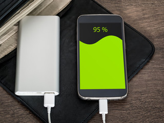 Smartphone charging with power bank. 95 percent of charge