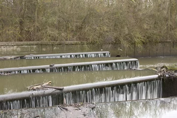  Weir on the River Brent. The river Brent runs down to the Thames river. To control the flow of the water a weir has been built in a country park on the outskirts of London. © janecampbell21