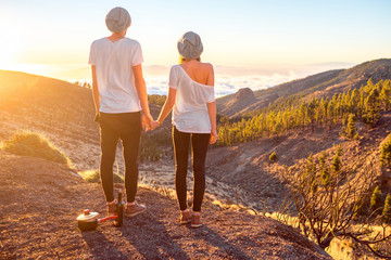Young couple standing together on the beautiful landscape background