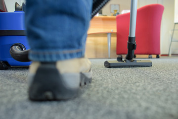 Closeup of vacuum and sneaker