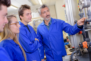 Tutor explaining pipework to students