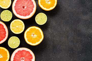 Mix of citrus fruits on dark table