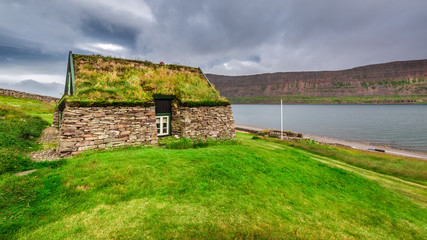 Fototapeta na wymiar Cottage covered with grass on the roof in Iceland