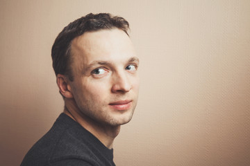 Fototapeta premium Young Caucasian man studio portrait over gray wall