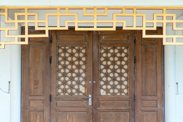 Brown wood door with vintage chinese style in the temple