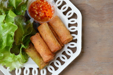 deep fried spring roll and sweet chili sauce on dish