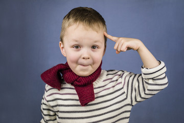 boy twisted his finger to his temple