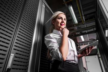 Young engineer businesswoman in server room