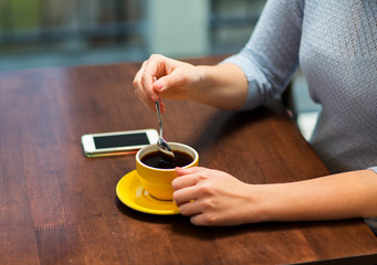 Fototapeta na wymiar close up of woman with smartphone and coffee