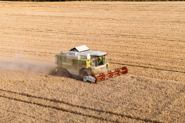 Fototapeta na wymiar aerial view of combine on harvest field