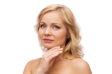 smiling woman with bare shoulders touching face