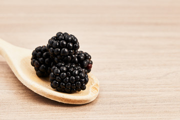 blackberries on a wooden spoon
