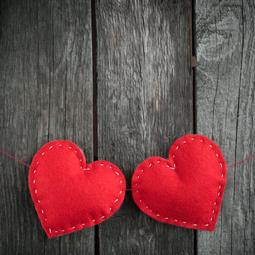 Two red hearts placed nicely on vintage wood background