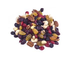a handful of dried fruit and nuts on a white background