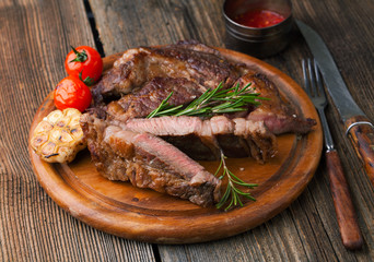 Grilled ribeye steak marbled meat with salt, rosemary and garlic