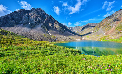 Mountain range near the lake and alpine meadow