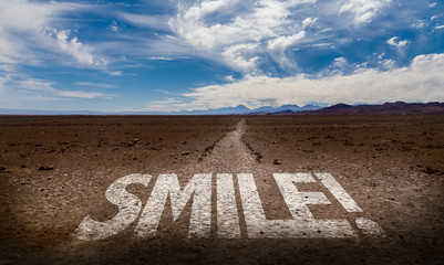 Smile! written on desert road